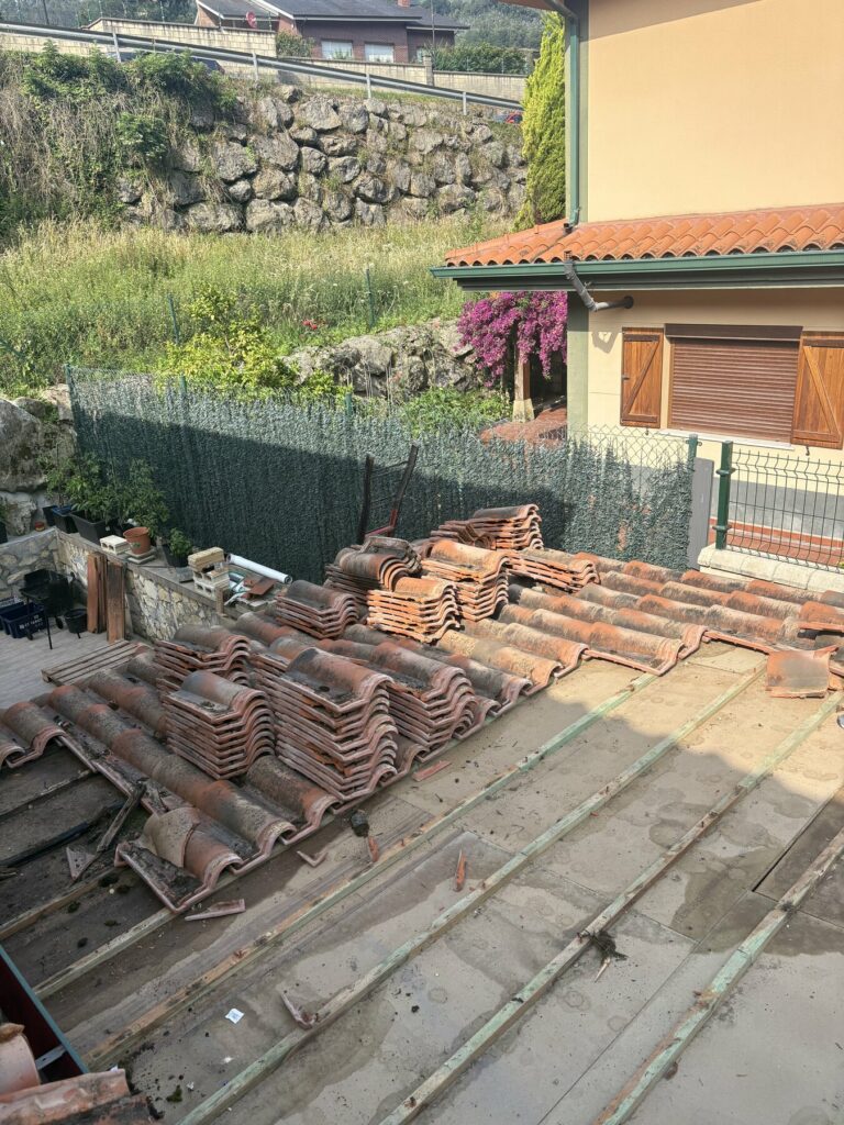 Desmontaje de la teja vieja en un retejado en Castro Urdiales